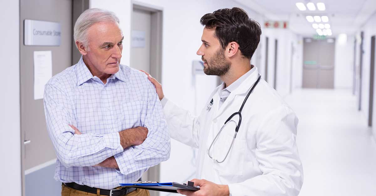 Doctor interacting with patient in corridor