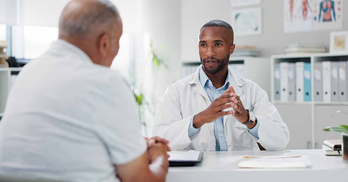 man talking to male doctor