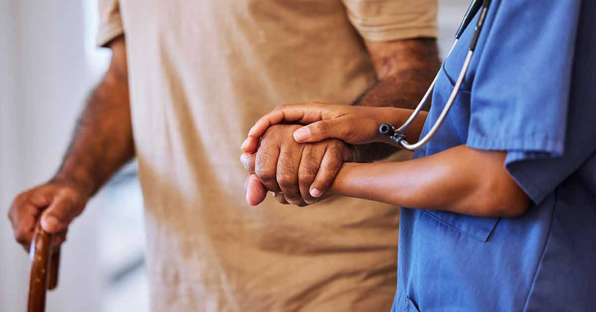 Nurse holding a patients hand