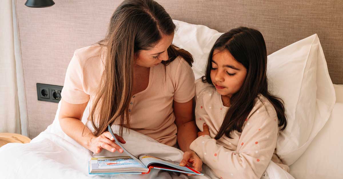 Woman reading to daughter